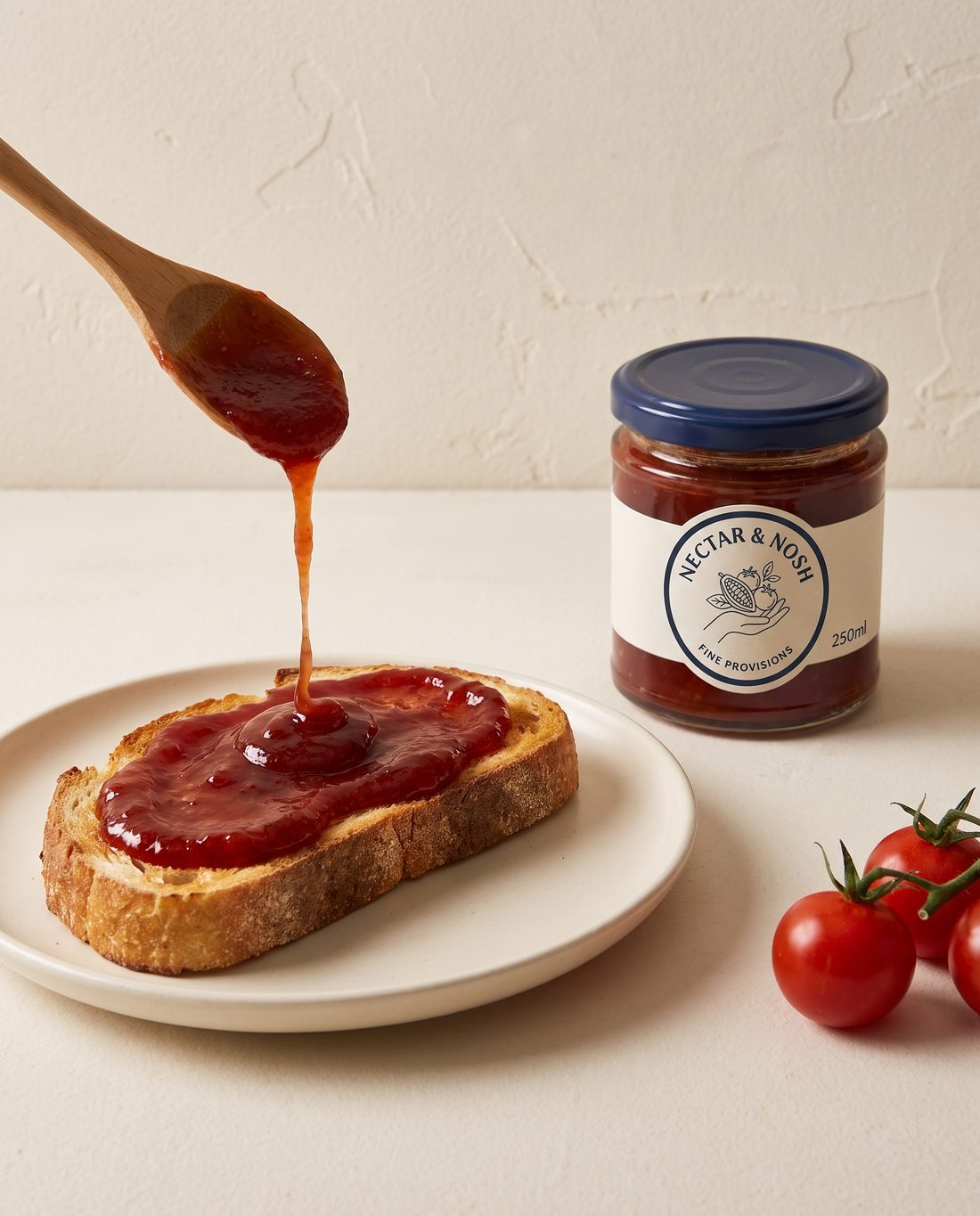 Sourdough toast with a thick layer of tomato jam beside the jar